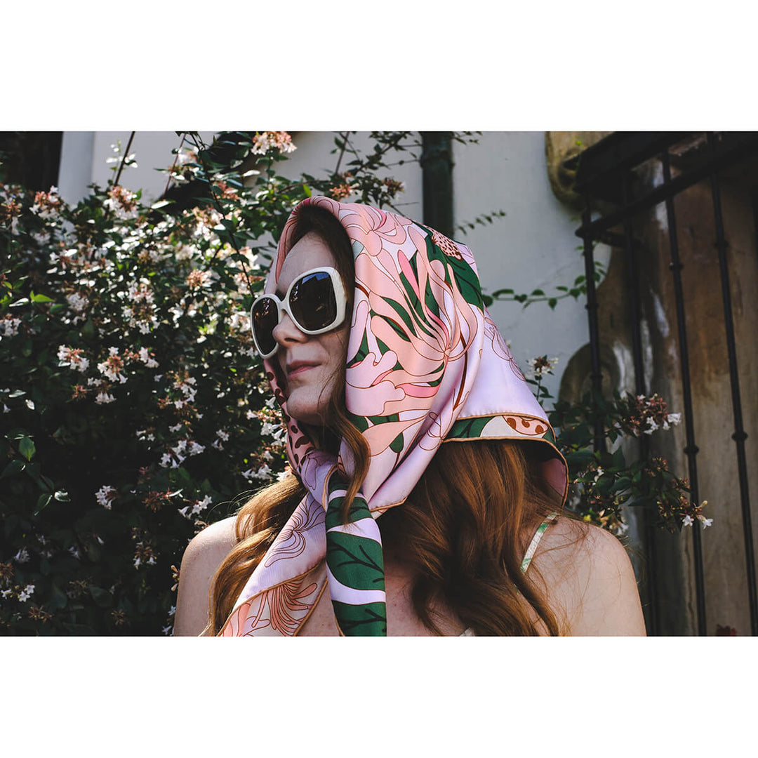 Model wearing a pink silk 'Jungle Gathering' scarf on her head by Jessie Zhao New York