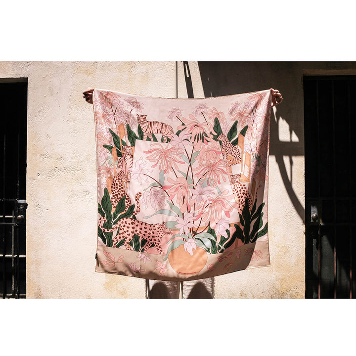 Silk scarf artistry with pink hues, leopards, tigers, and botanical details modeled